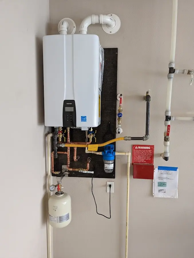 Professional plumber installing copper piping in a Millville home